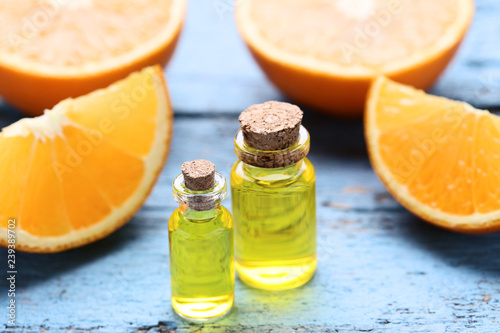 Orange oil in bottles on blue wooden table