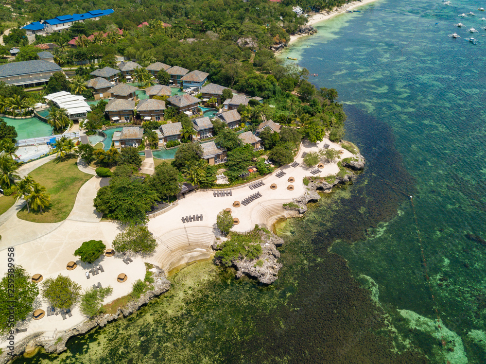 Aerial view of Panglao island. Beautiful tropical island landscape with reef coastline and resorts. Bohol, Philippines.