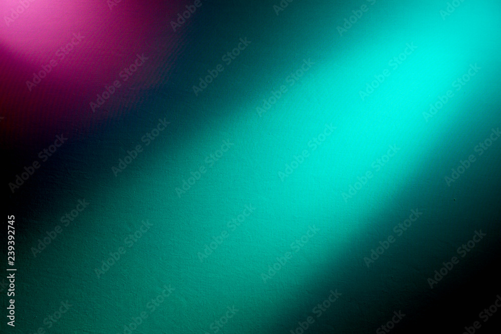 Obraz premium Turquoise ray of light and pink spot on a black background