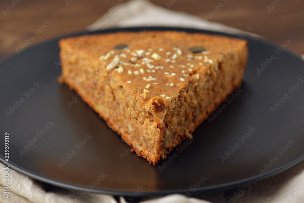 piece of pecan pie on a black plate at an angle of 45 piece of pecan pie on a black plate at an angle of 45