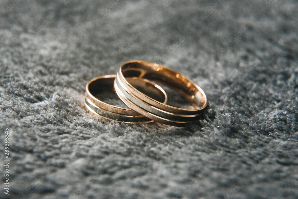Wedding wedding rings on a gray background, selective focus, macro Wedding wedding rings on a gray background, selective focus, macro
