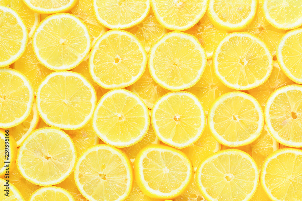 A slices of fresh juicy yellow lemons.  Texture background, pattern.