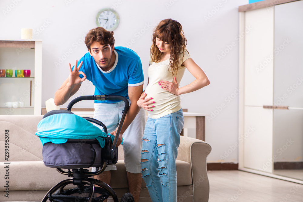 Young parents with baby expecting new arrival Young parents with baby expecting new arrival