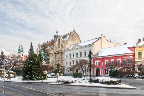 Sopron old town winter cityscape: Szechenyi Square, the statue of Istvan Szechenyi, the Dominican Church and the Post Palace covered in snow