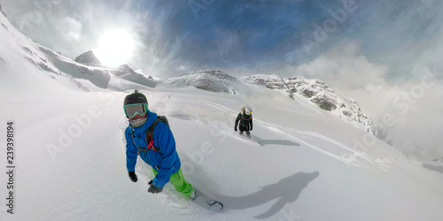360 VR: Active female and male tourists snowboarding off trail in the Rockies.
