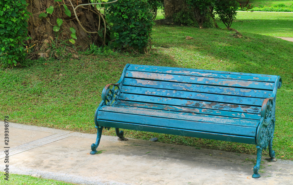 Turquoise Blue Colored Wood with Wrought Iron Bench in the Green Garden Turquoise Blue Colored Wood with Wrought Iron Bench in the Green Garden