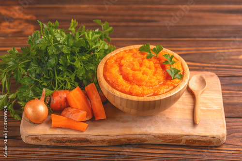 Bright tasty pureed carrot soup with ingredients