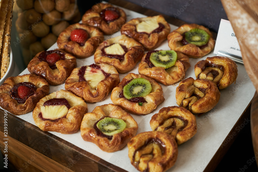 Danish pastry buns with fresh fruit kiwi, strawberry, pineapple Danish pastry buns with fresh fruit kiwi, strawberry, pineapple
