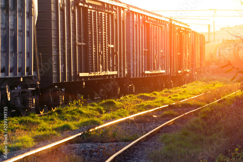 Loading freight cars, the sun shines on the mirrored rails, rails and sleepers