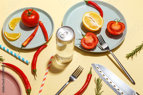 Red hot peppers, tomatoes, rosemary and spices on ligth-yellow background. Table setting. Top view.