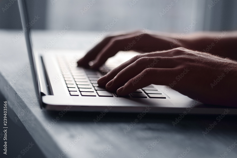 close up.hand of a businessman pressing button on laptop keyboar close up.hand of a businessman pressing button on laptop keyboar