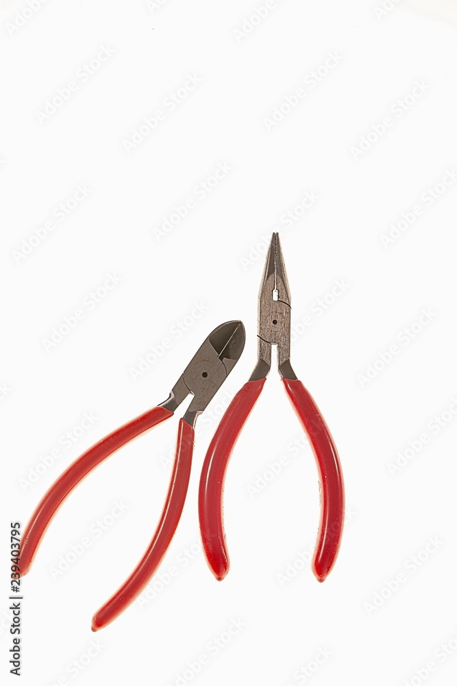 Beautiful hobby snipe-nose pliers and side cutters isolated on white background. Tools for hobby. Free time / interest concept. Beautiful hobby snipe-nose pliers and side cutters isolated on white background. Tools for hobby. Free time / interest concept.