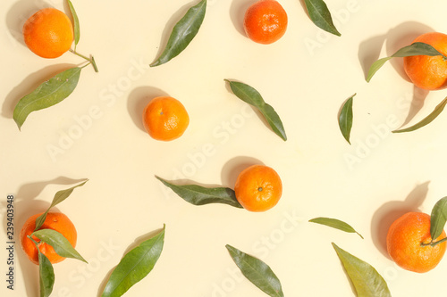 Citrus food on ligth-yellow background - assorted citrus fruits with mint leaves. Top view.