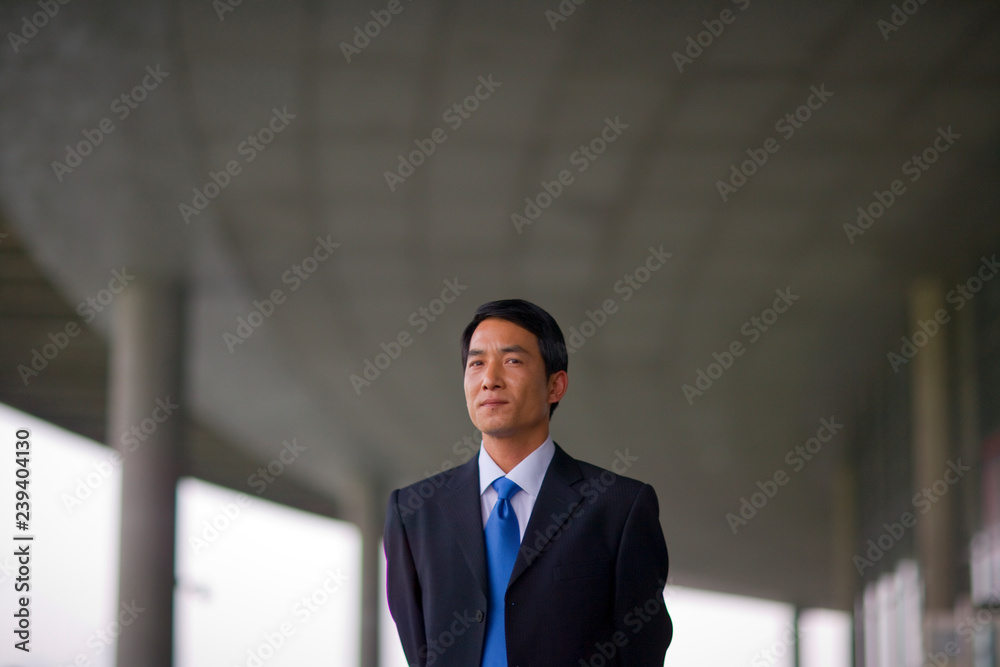 Portrait of a mid-adult man standing outside a building. Portrait of a mid-adult man standing outside a building.