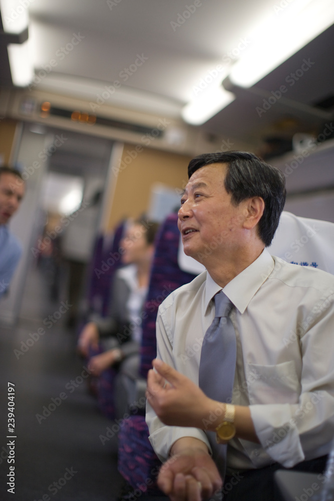 Mature businessman sitting on a train. Mature businessman sitting on a train.