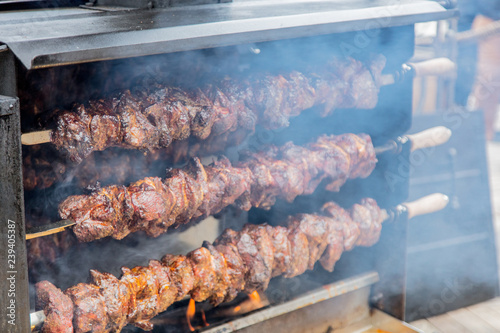 Traditional european grilled meat with smoke on Christmas fair