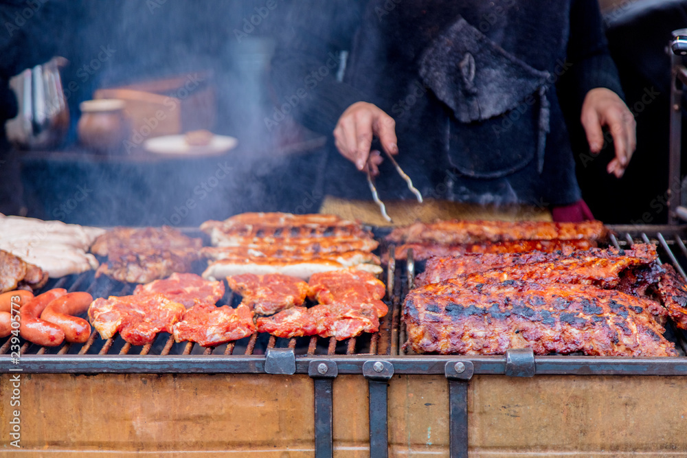 Traditional european grilled meat with smoke on Christmas fair