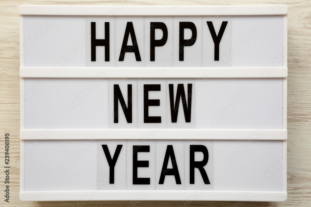 'Happy new year' words on lightbox over white wooden surface, top view. Overhead, flat lay, from above. 2019 'Happy new year' words on lightbox over white wooden surface, top view. Overhead, flat lay, from above. 2019