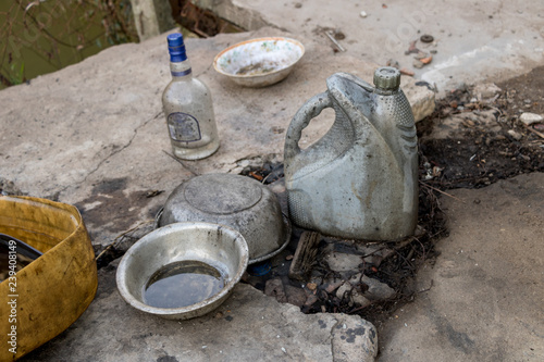 Wallpaper Mural Dirty Chrome Bowls and Empty Plastic Can with No Label on Messy Floor - Recycled Wine Bottle Torontodigital.ca
