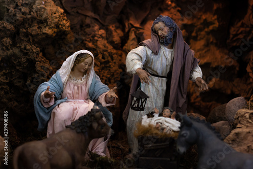 Traditional nativity scene with Virgin Mary, Joseph and child Jesus on crib with ox and donkey nearby. Christmas holiday season, Christian religion set concepts
