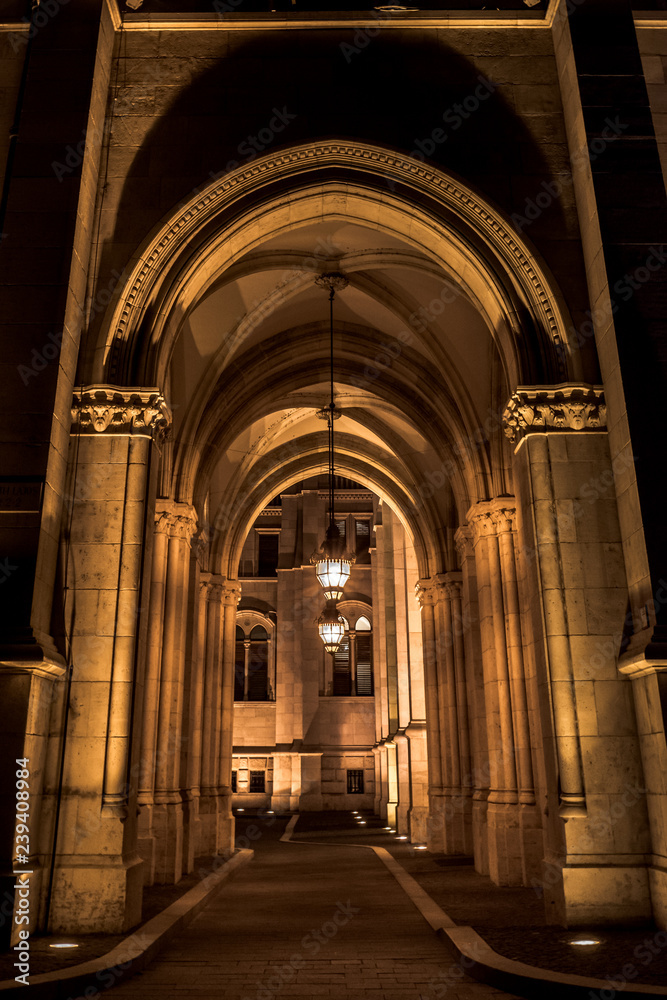Night view of the arches of the Budapest Parliament with central lamps, Hungary