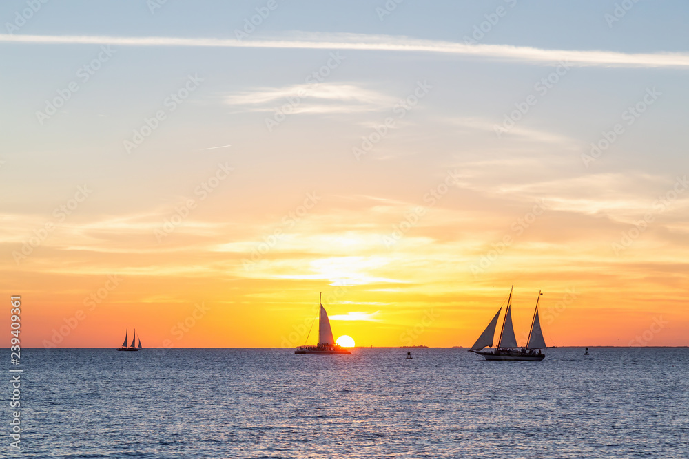Fototapeta premium Beautiful golden sunset viewed from Mallory Square in Key West, Florida Keys, United States.
