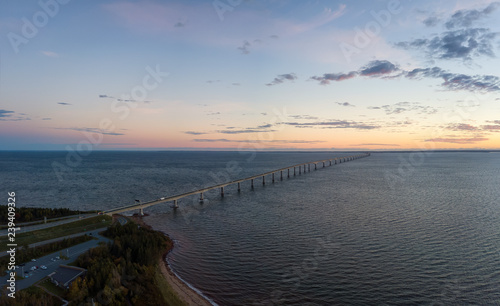 Aerial Panoramic view of Confederation Bridge to Prince Edward Island during a vibrant sunny sunrise. Taken in Cape Jourimain National Wildlife Area, New Brunswick, Canada.