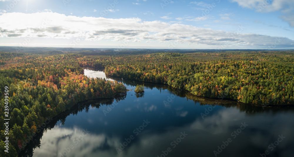 Aerial panoramic view of a beautiful lake during a sunny autumn day. Taken in Charlotte Lake, Queens, Caledonia, Nova Scotia, Canada.
