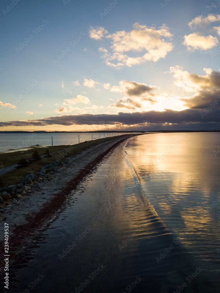 Aerial view of a beautiful beach on the Atlantic Ocean during a cloudy sunrise. Taken at Crescent Beach, Nova Scotia, Canada. Aerial view of a beautiful beach on the Atlantic Ocean during a cloudy sunrise. Taken at Crescent Beach, Nova Scotia, Canada.