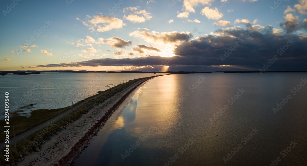 Aerial panoramic view of a beautiful beach on the Atlantic Ocean during a cloudy sunrise. Taken at Crescent Beach, Nova Scotia, Canada.
