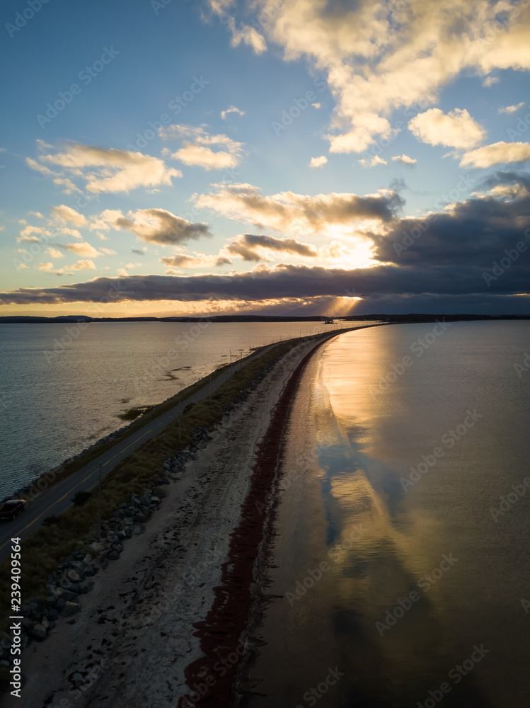 Aerial view of a beautiful beach on the Atlantic Ocean during a cloudy sunrise. Taken at Crescent Beach, Nova Scotia, Canada.