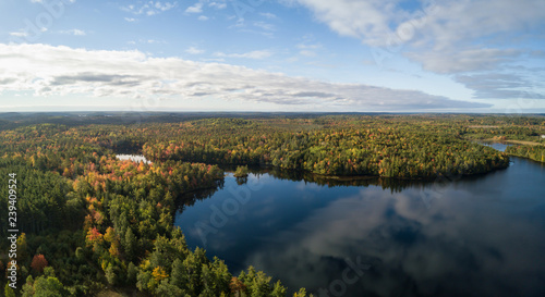 Aerial panoramic view of a beautiful lake during a sunny autumn day. Taken in Charlotte Lake, Queens, Caledonia, Nova Scotia, Canada.