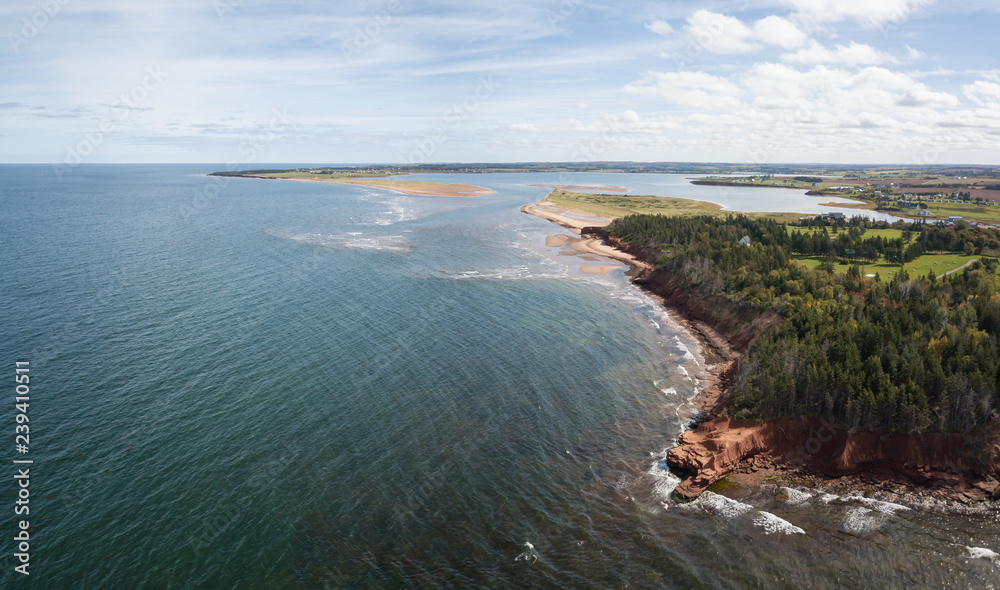 Aerial panoramic view of a beautiful rocky shore on the Atlantic Ocean. Taken in Cabot Beach Provincial Park, Prince Edward Island, Canada.