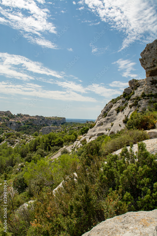 Vacation tourist destination in France, Alpilles mountains gorge in Provence, green pine forests and white stones