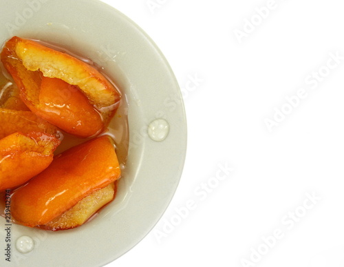  Orange peel preserve in a little white plate isolated on white background (top view). Glyko- koutaliou- portokali. photo