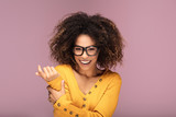 Young afro woman wearing eyeglasses, smiling.