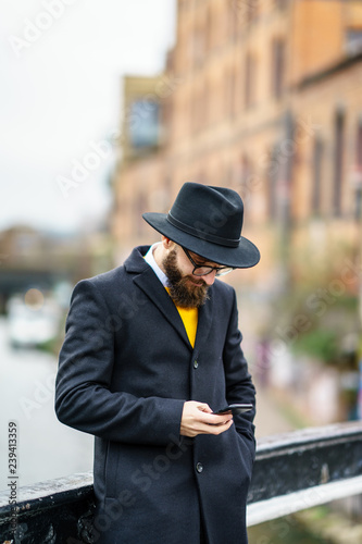 good looking beard man using mobile 
