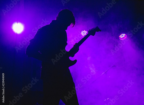 silhouette of a man playing guitar