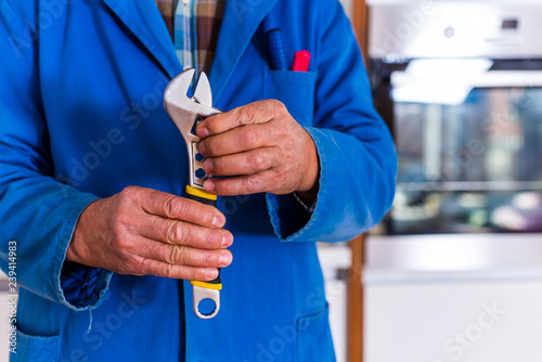 Old craftsman showing his wrench tool