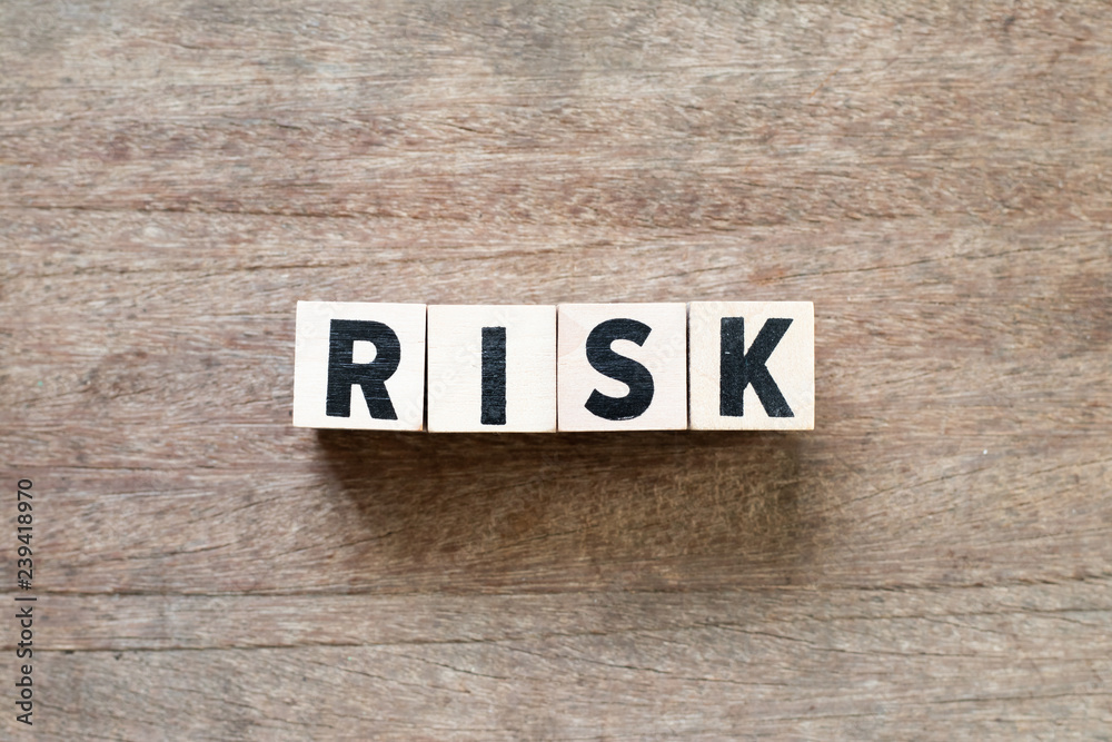 Fototapeta premium Wood letter block in word risk on wood background