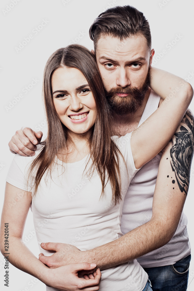 Happy couple embracing and looking camera on white background Happy couple embracing and looking camera on white background