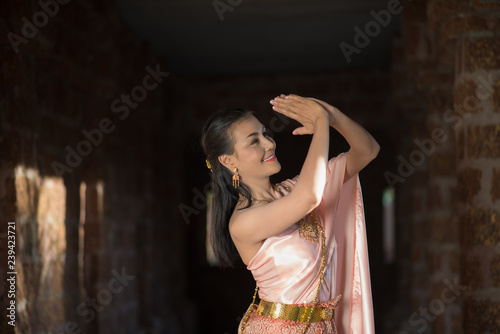 Beautiful Woman wearing typical Thai dress © Johnstocker
