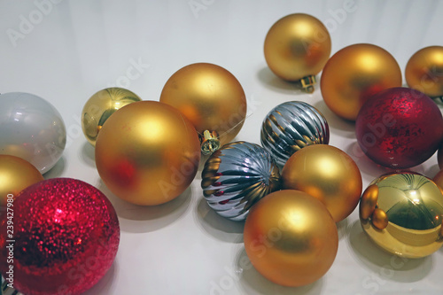 scattered multicolored christmas balls on white background