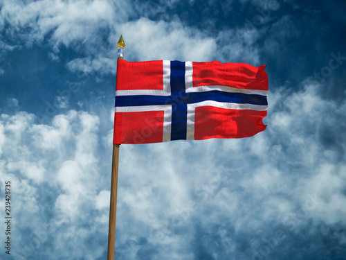 Norway flag Silk waving made transparent fabric flag of Norway with wooden flagpole gold spear on background sunny blue sky white smoke clouds real retro photo Countries of world 3d illustration