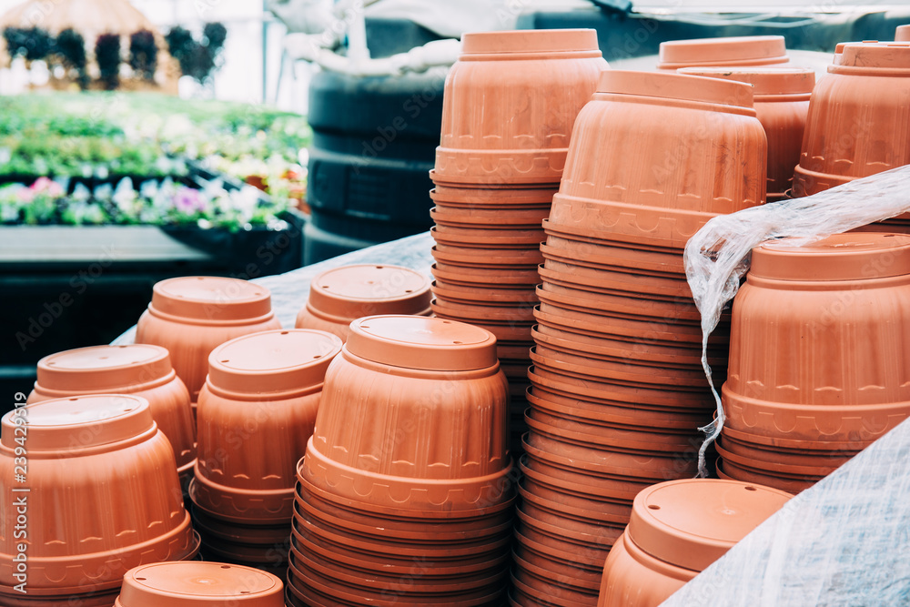 Stacks of plastic pots for growing in modern hydroponic greenhouse interior Stacks of plastic pots for growing in modern hydroponic greenhouse interior