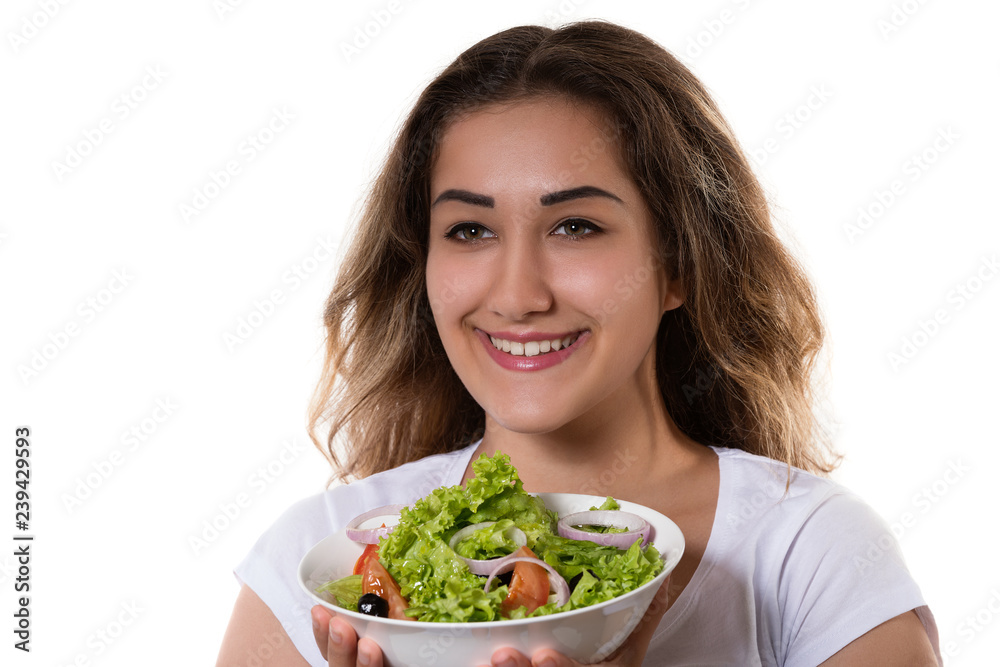 Healthy lifestyle young girl holding a bowl with fresh salad smiling happy Healthy lifestyle young girl holding a bowl with fresh salad smiling happy
