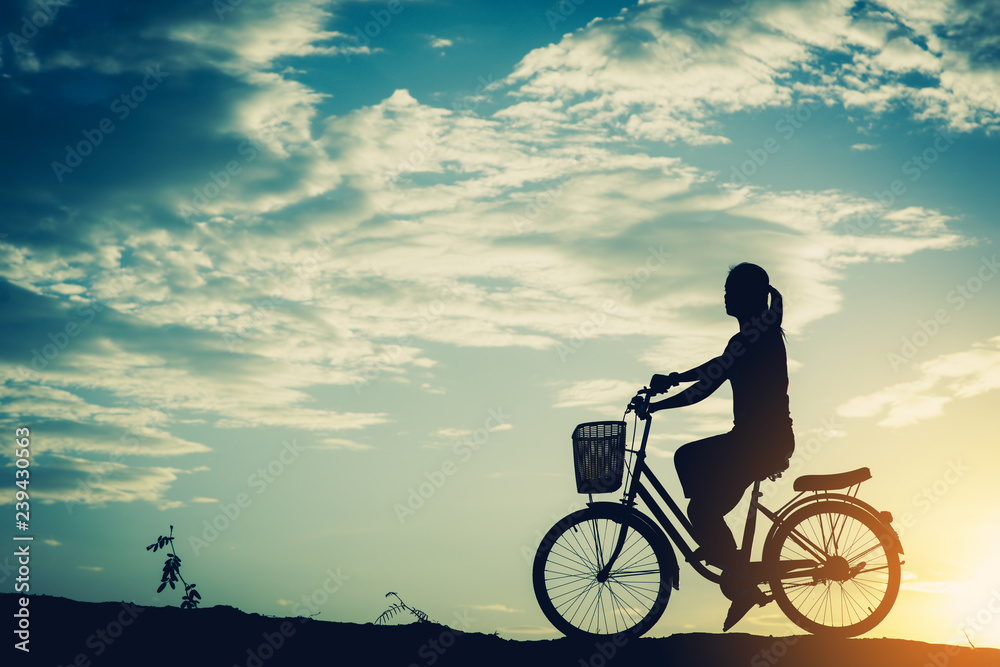 Fototapeta premium Silhouette of women with bicycle and beautiful sky