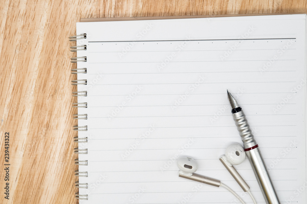 close up ink pen and headphone, and blank notebook. concept of music writing, idea creative and thinking with text space close up ink pen and headphone, and blank notebook. concept of music writing, idea creative and thinking with text space
