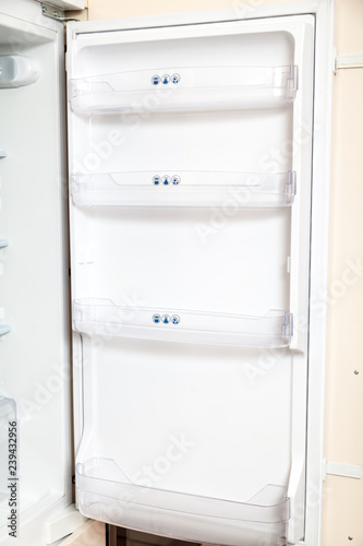Open door of modern refrigerator
