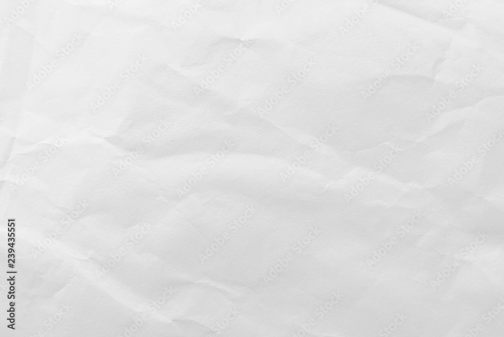 Fototapeta premium White crumpled paper texture background. Close-up.